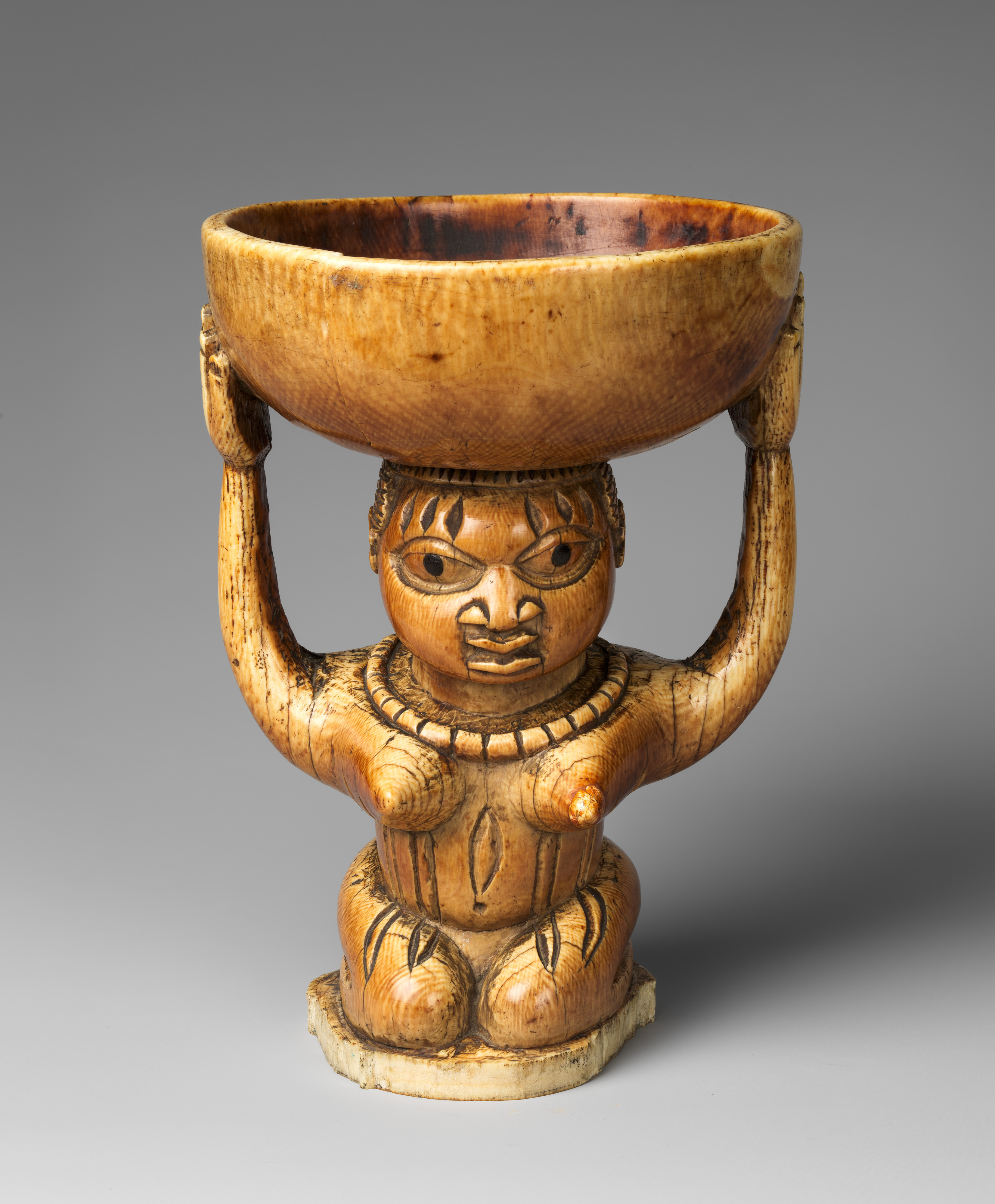Àgéré Ifá (Ifá divination vessel) with kneeling woman (MET 1991.17.127) DP-31157-001